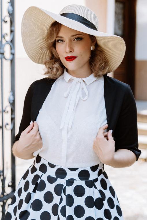 A model wearing a Monochrome Polka Dot Swing Skirt and Black Bolero Jacket