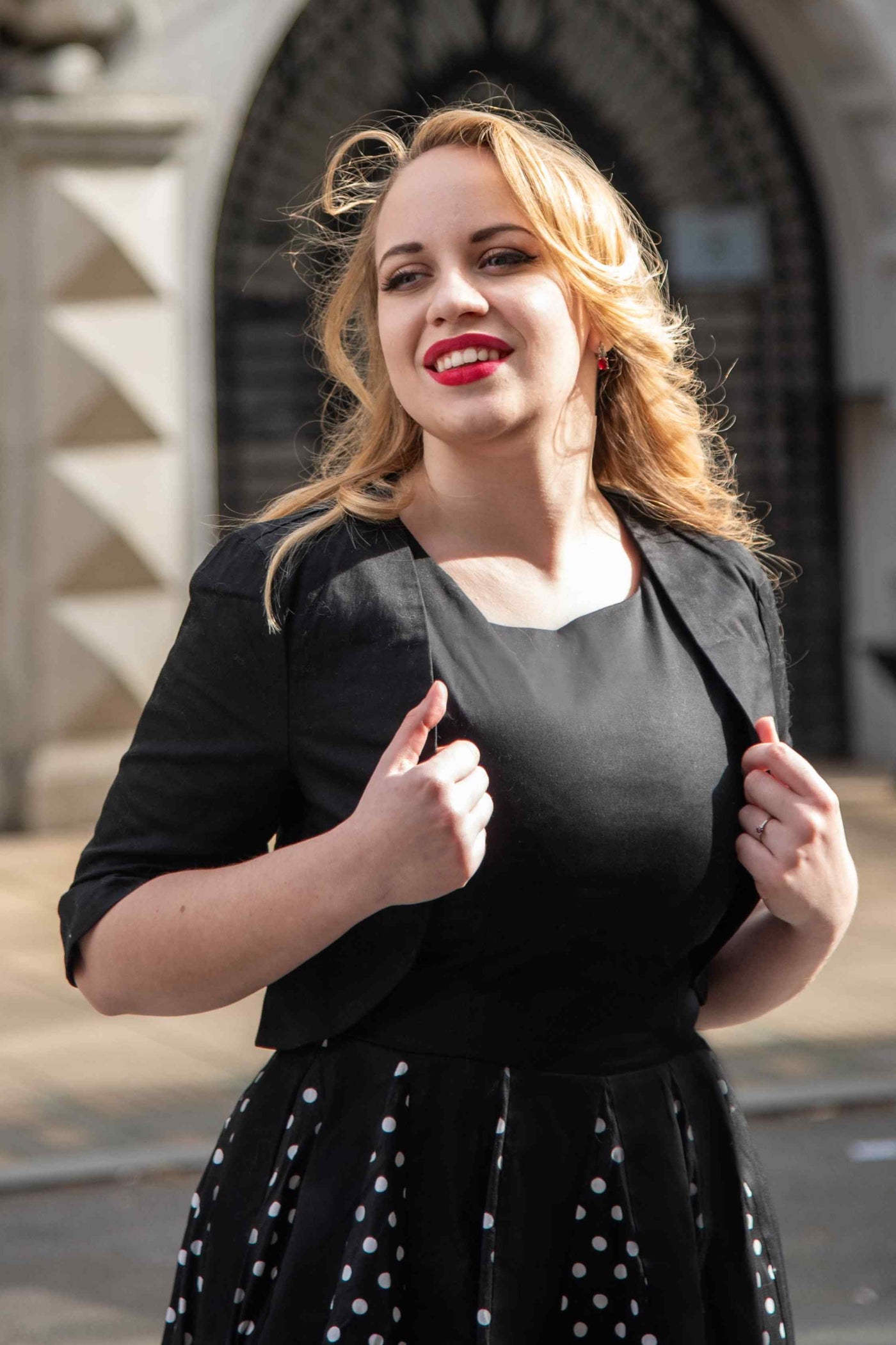 A model wearing a Monochrome Polka Dot Swing Skirt and Black Bolero Jacket