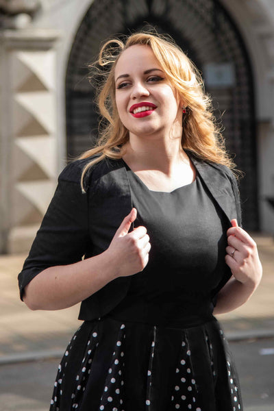 A model wearing a Monochrome Polka Dot Swing Skirt and Black Bolero Jacket