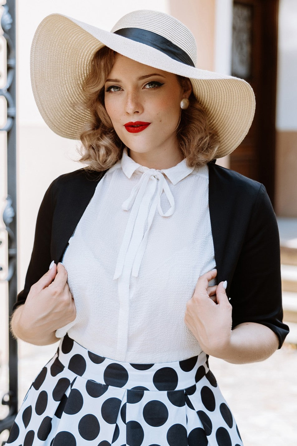 A model wearing a Monochrome Polka Dot Swing Skirt and Black Bolero Jacket