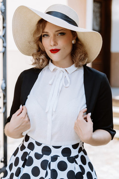 A model wearing a Monochrome Polka Dot Swing Skirt and Black Bolero Jacket
