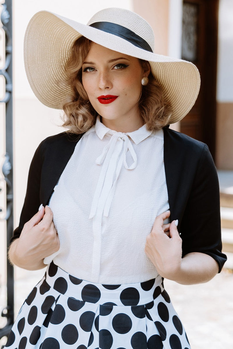 A model wearing a Monochrome Polka Dot Swing Skirt and Black Bolero Jacket