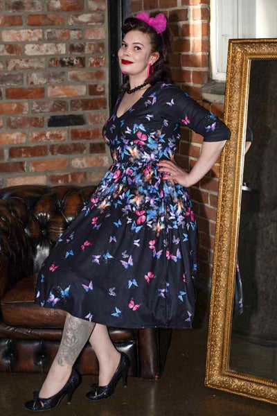 A lady wearing a Black Butterfly Long Sleeved Dress