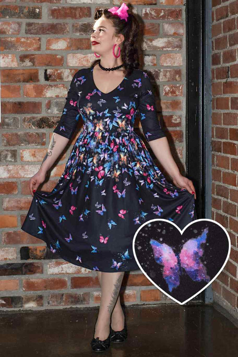 A lady wearing a Black Butterfly Long Sleeved Dress