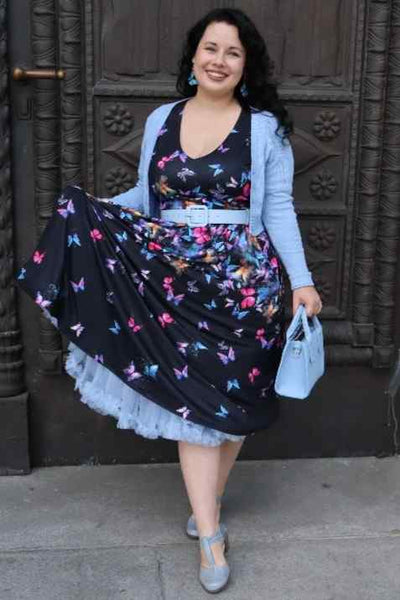 A lady wearing a Black Butterfly Long Sleeved Dress