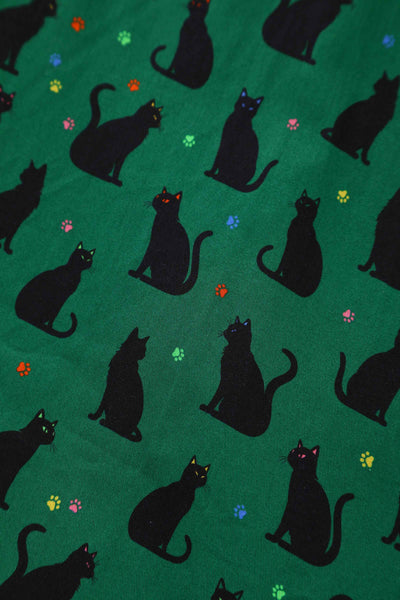 Close up view of Black Cat Midi Shirt Dress In Green