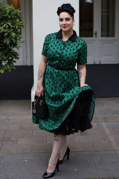 A lady wearing a Mabel Black Cat Midi Shirt Dress In Green
