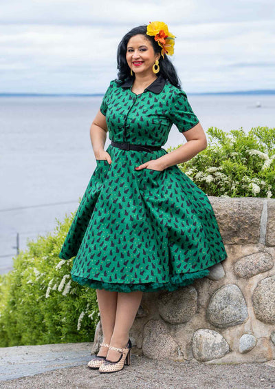 A model wearing a Mabel Black Cat Midi Shirt Dress In Green
