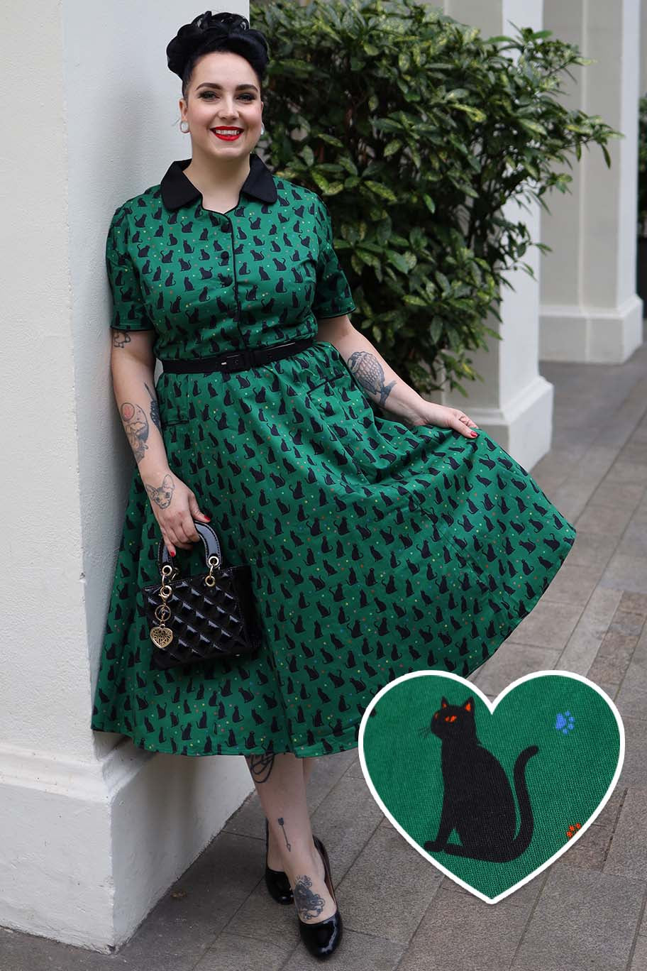 A model wearing a Mabel Black Cat Midi Shirt Dress In Green