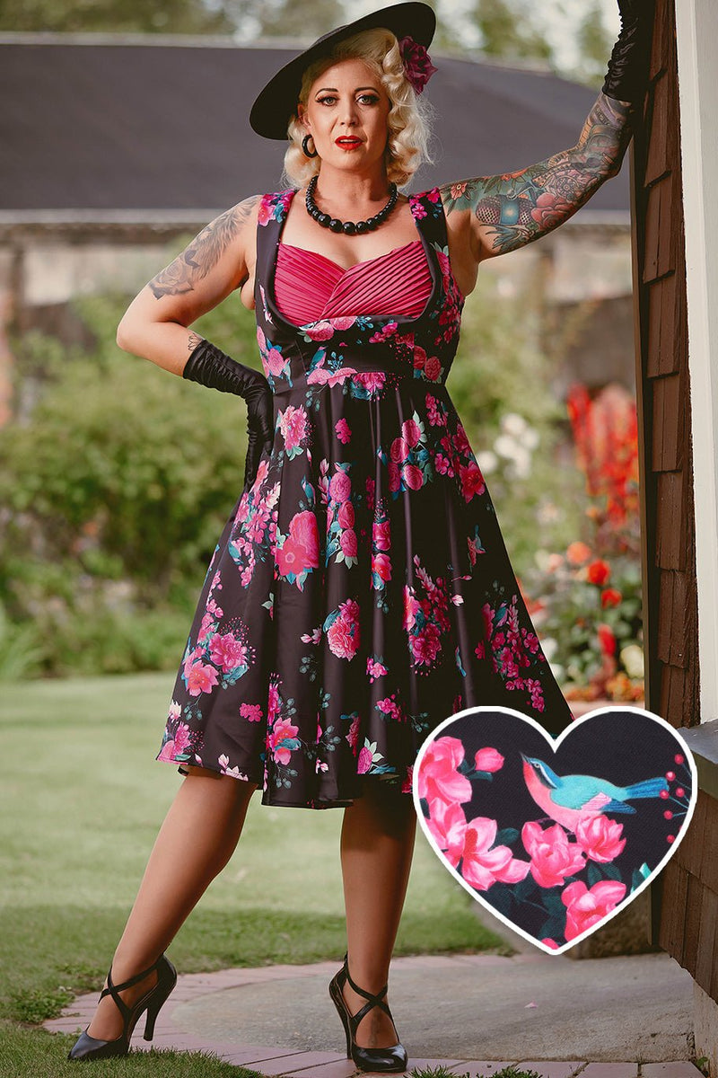 A lady wearing a Black Floral Pleated Bust Dress