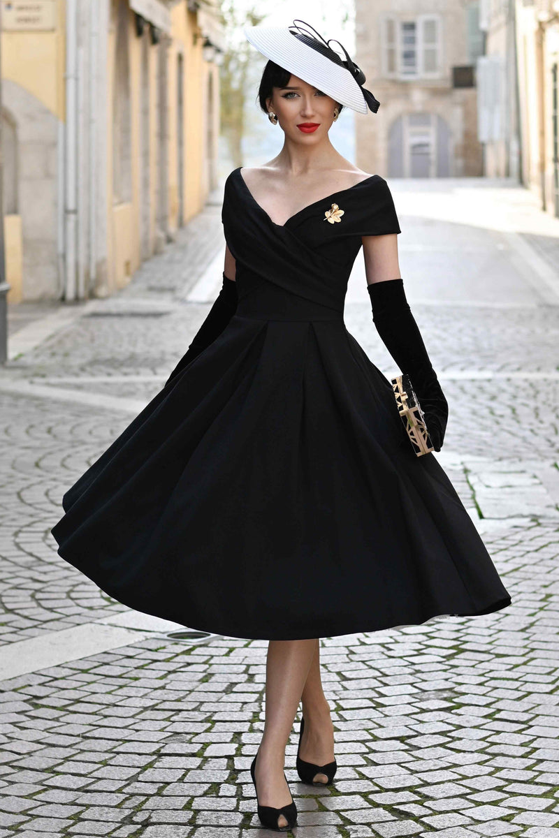 A model wearing a Black Off Shoulder Dress