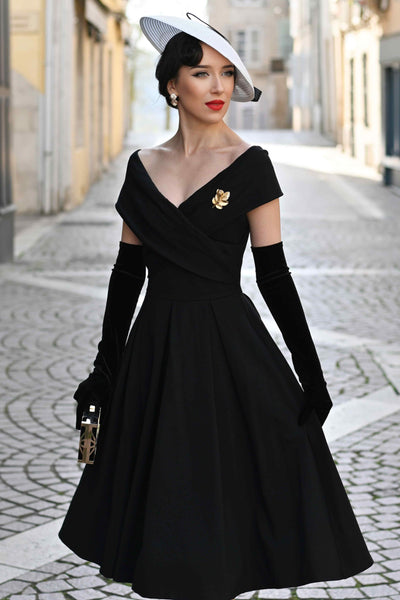 A model wearing a Black Off Shoulder Dress