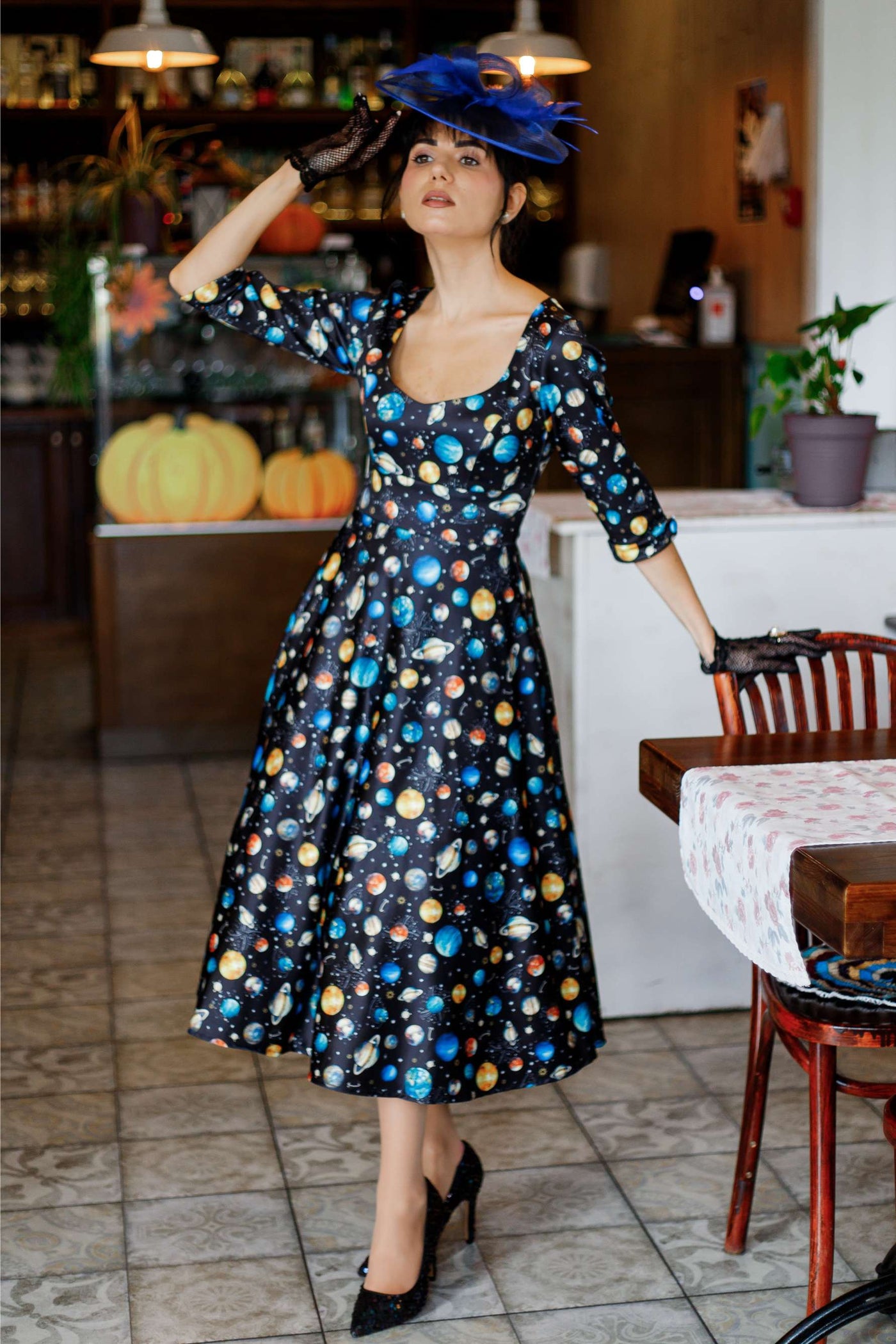 An elegant lady wearing a Scarlette Black Planet Dress