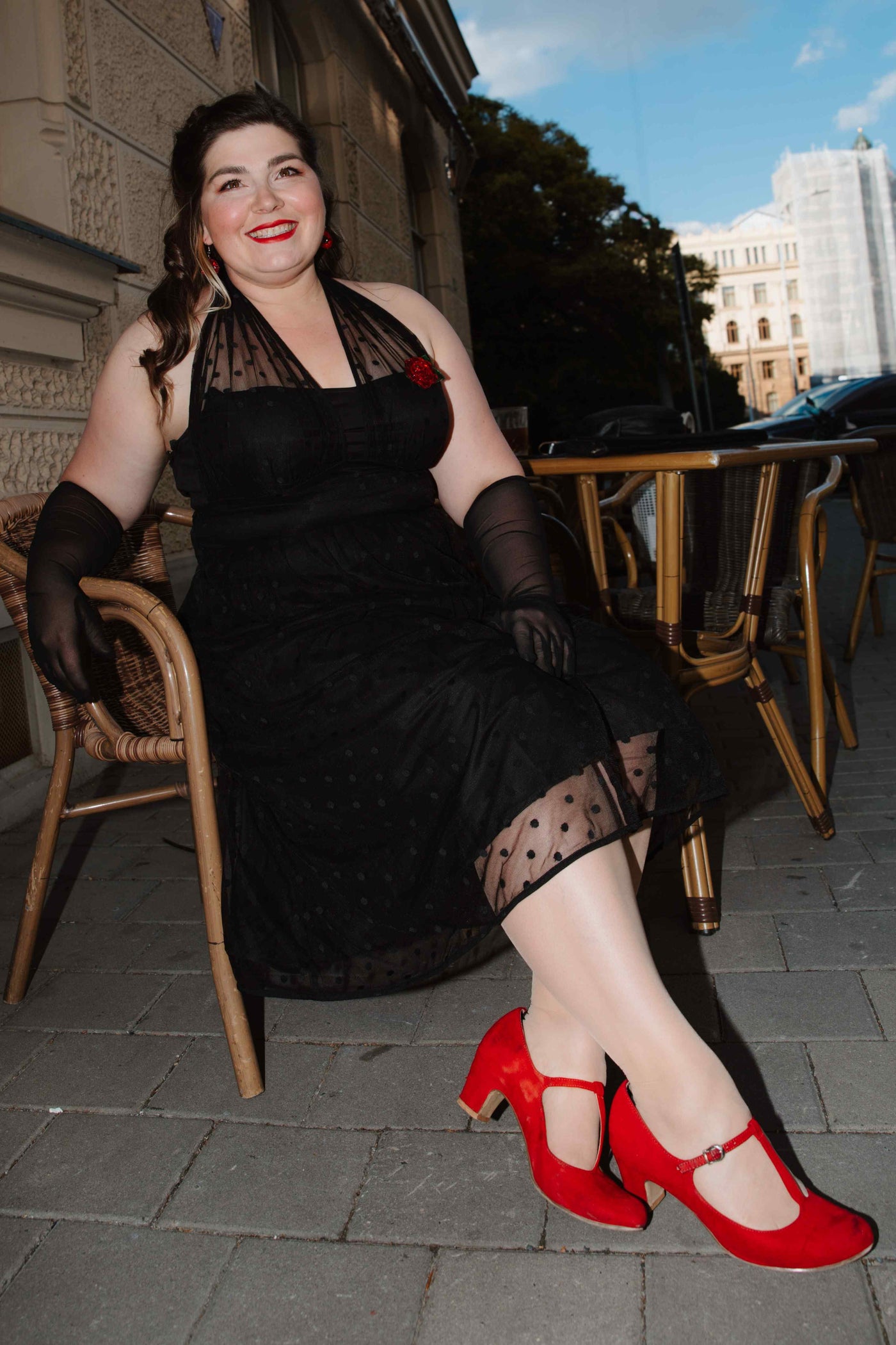 A lovely model wearing a Dorothea Black Polka Dot Mesh Halter Dress