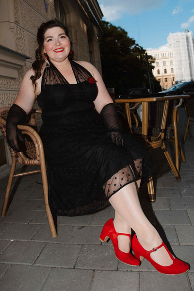 A lovely model wearing a Dorothea Black Polka Dot Mesh Halter Dress
