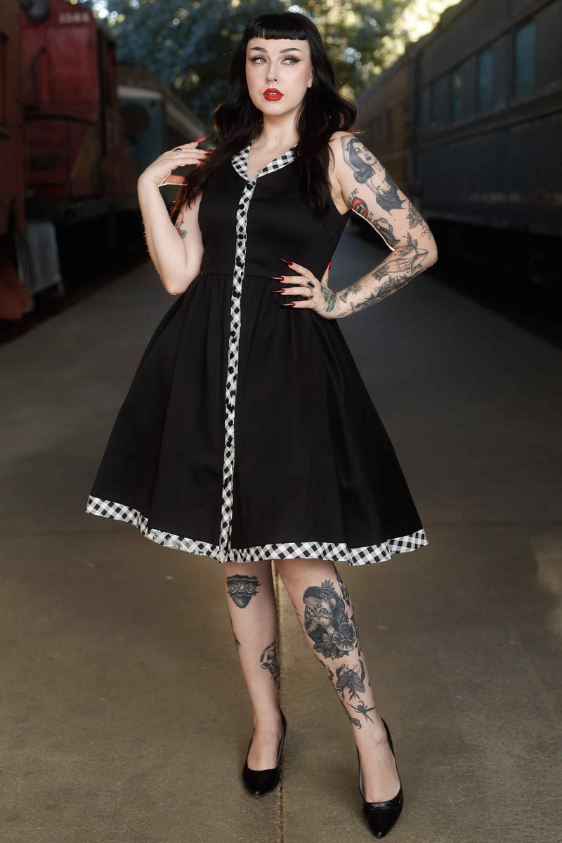 A model wearing Black Sleeveless Shirt Dress With Gingham Stripes
