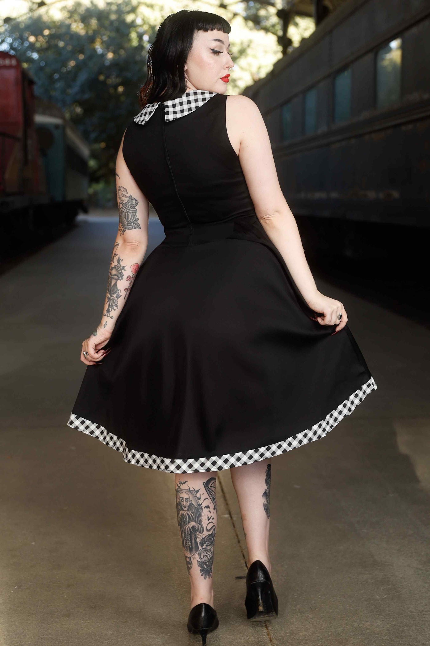 Back view of model wearing Black Sleeveless Shirt Dress With Gingham Stripes