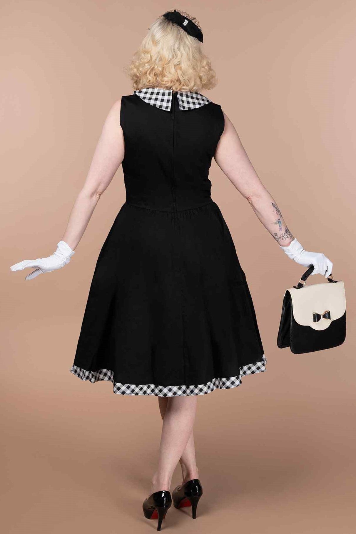 A model wearing a  Black Sleeveless Shirt Dress With Gingham Stripes