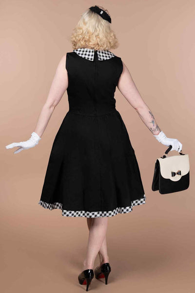 A model wearing a  Black Sleeveless Shirt Dress With Gingham Stripes