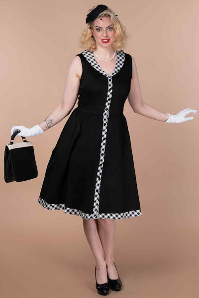 A model wearing a  Black Sleeveless Shirt Dress With Gingham Stripes