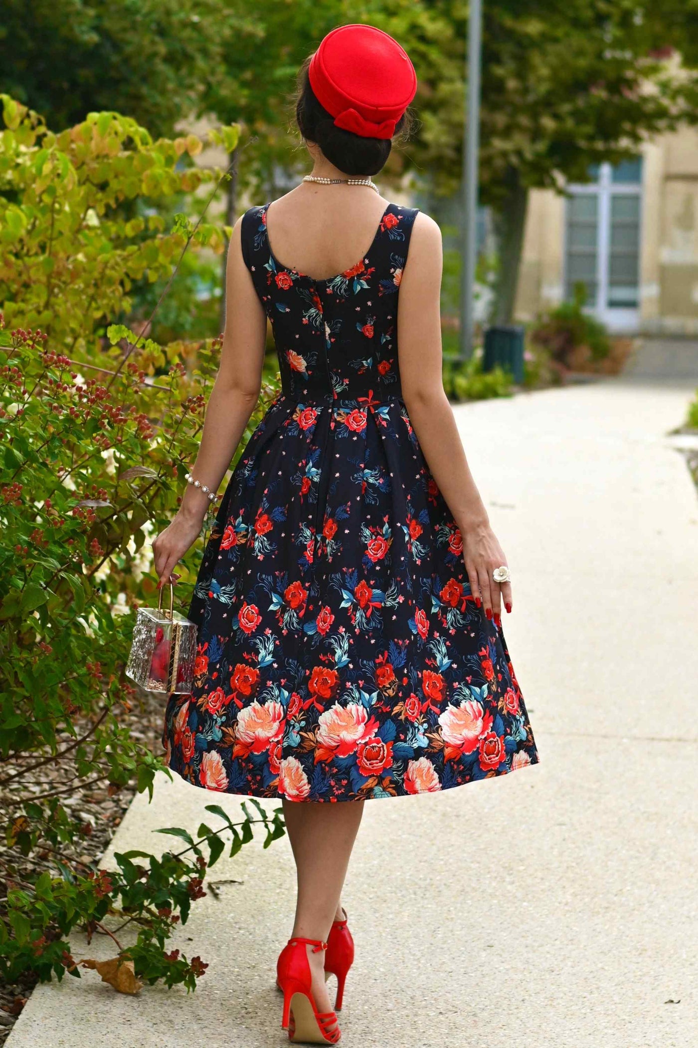 A lovely model wearing an Amanda Black Tapestry Floral Swing Dress