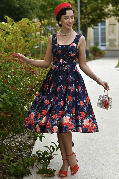A lady wearing an Amanda Black Tapestry Floral Swing Dress