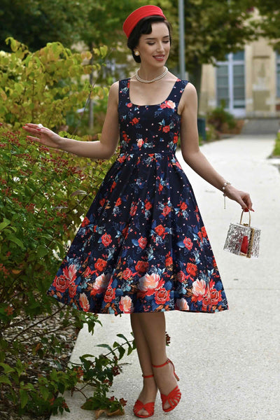 A lady wearing an Amanda Black Tapestry Floral Swing Dress