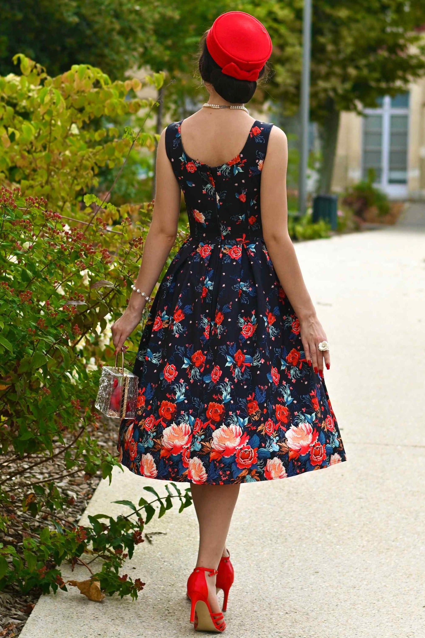 A lovely model wearing an Amanda Black Tapestry Floral Swing Dress