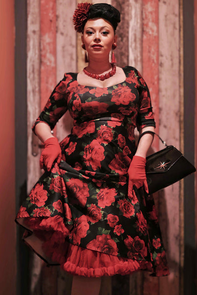 A model wearing a Black/Red Rose Long Sleeved Midi Dress