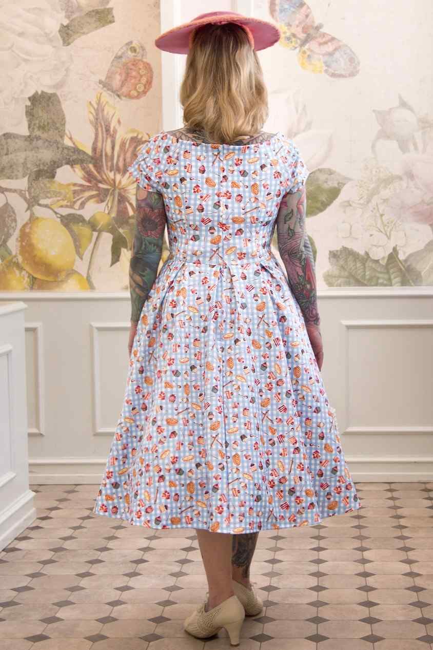 A model wearing Blue Gingham Off Shoulder Dress In Baking Print