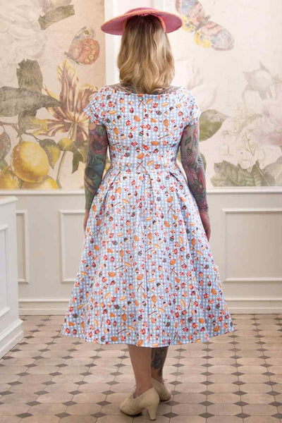 A model wearing Blue Gingham Off Shoulder Dress In Baking Print