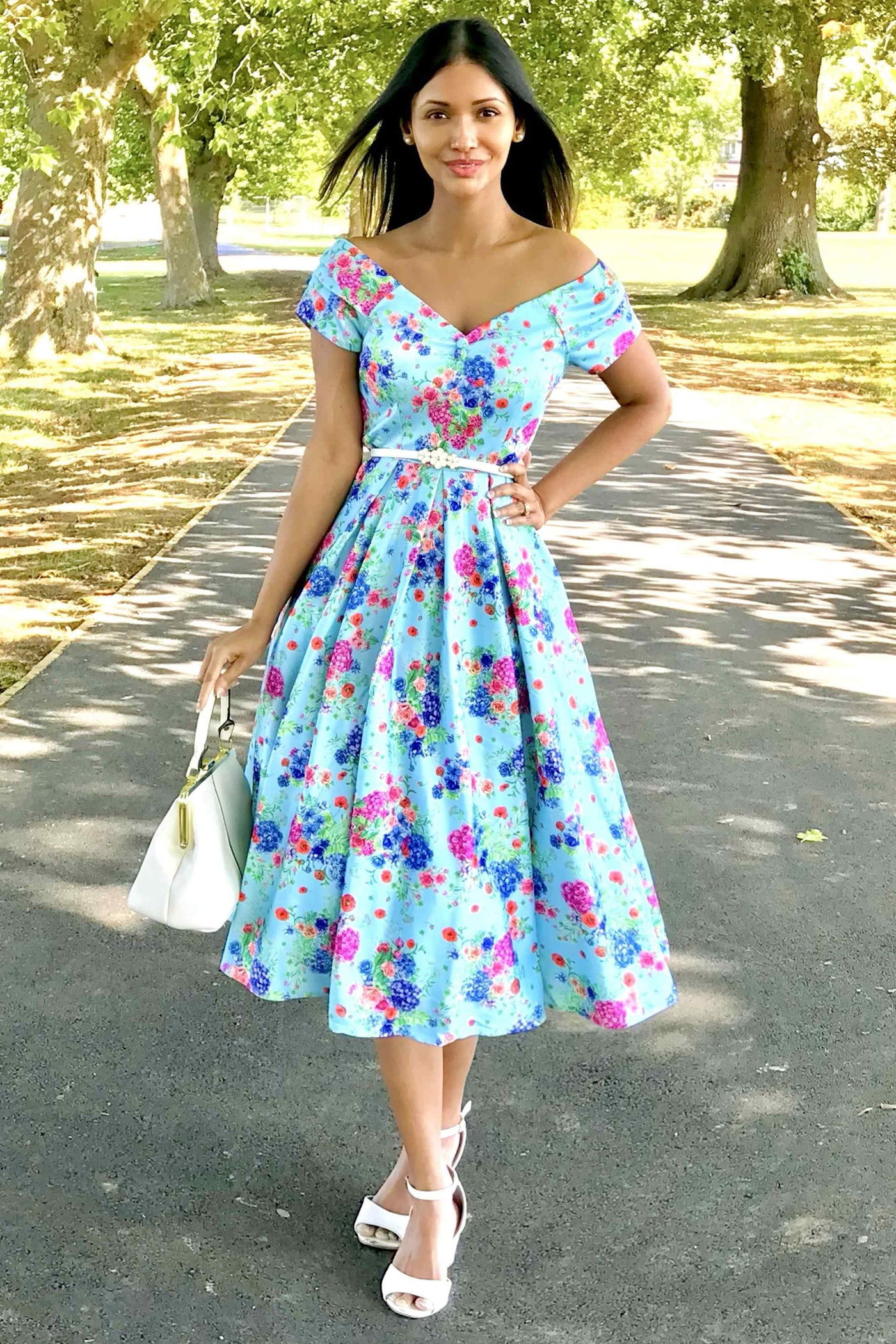 A model wearing Blue Hydrangea Off Shoulder Dress In Cotton