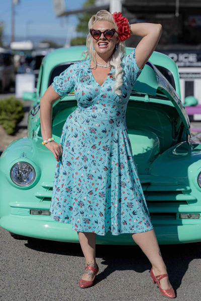 A lady wearing a Blue Nautical Tattoo Midi Dress