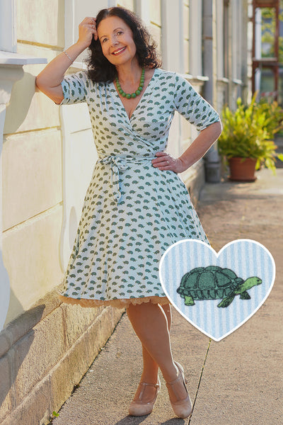 A model wearing Blue Sea Turtle Wrap Dress