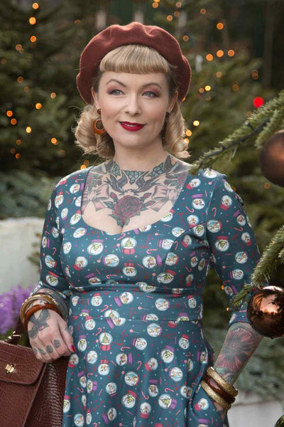 Close up view of model wearing Blue Snow Globe Long Sleeved Dress