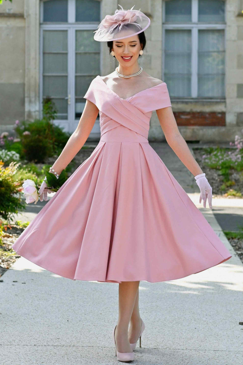 A woman wearing a Blush Pink Off Shoulder Dress