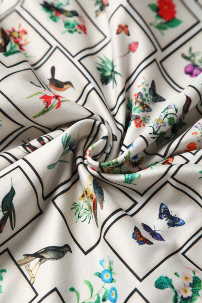 Close up view of Botanical and Bird  Print Flared Dress in Cream