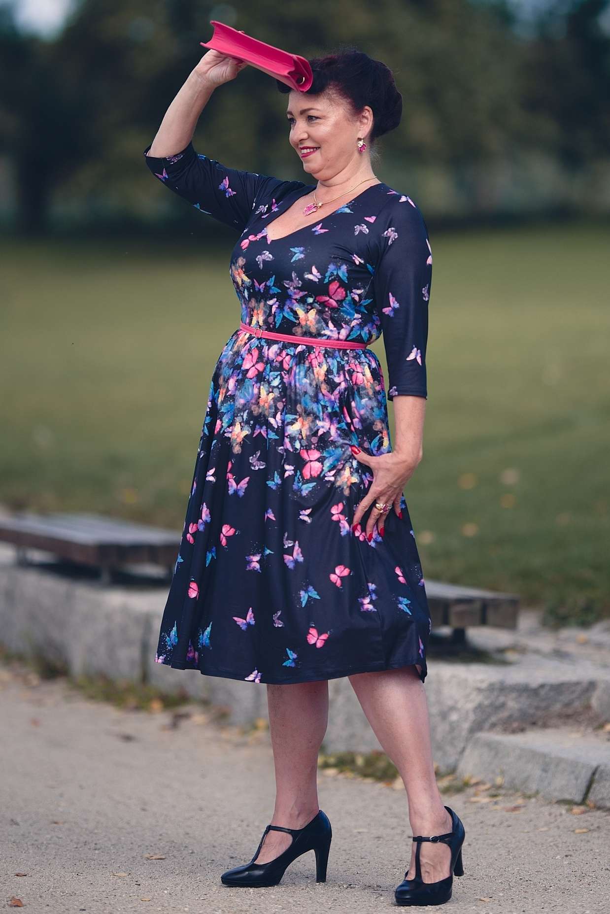A lovely woman wearing a Billie Black Butterfly Long Sleeved Dress