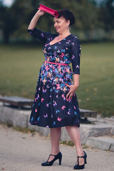A lovely woman wearing a Billie Black Butterfly Long Sleeved Dress