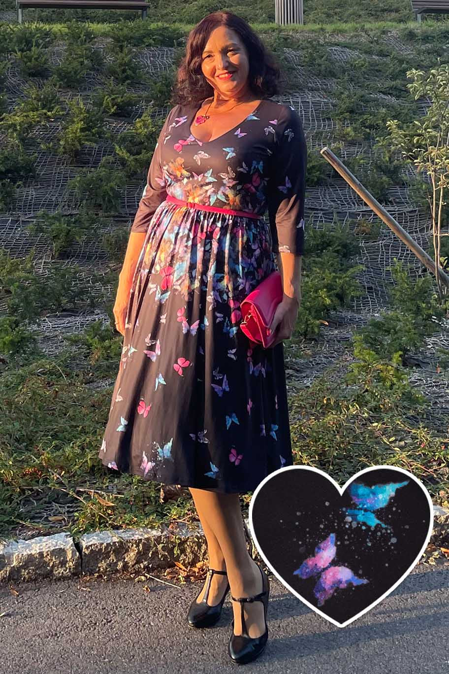 A woman wearing a Billie Black Butterfly Long Sleeved Dress