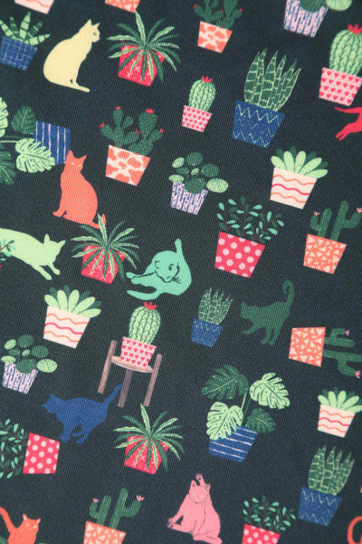 Close up view of Cat & Plant Dress In Dark Green