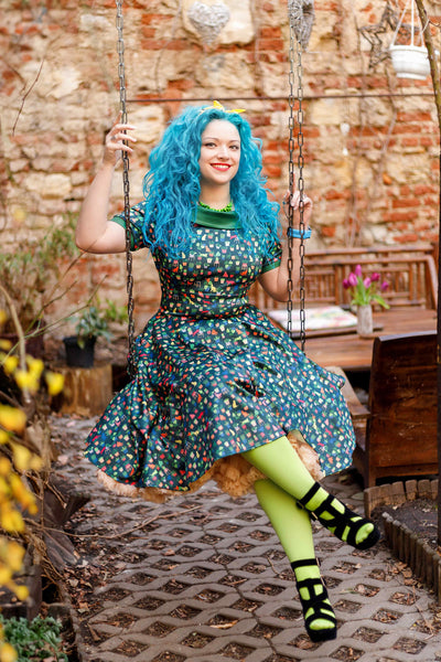 A model wearing Cat & Plant Dress In Dark Green