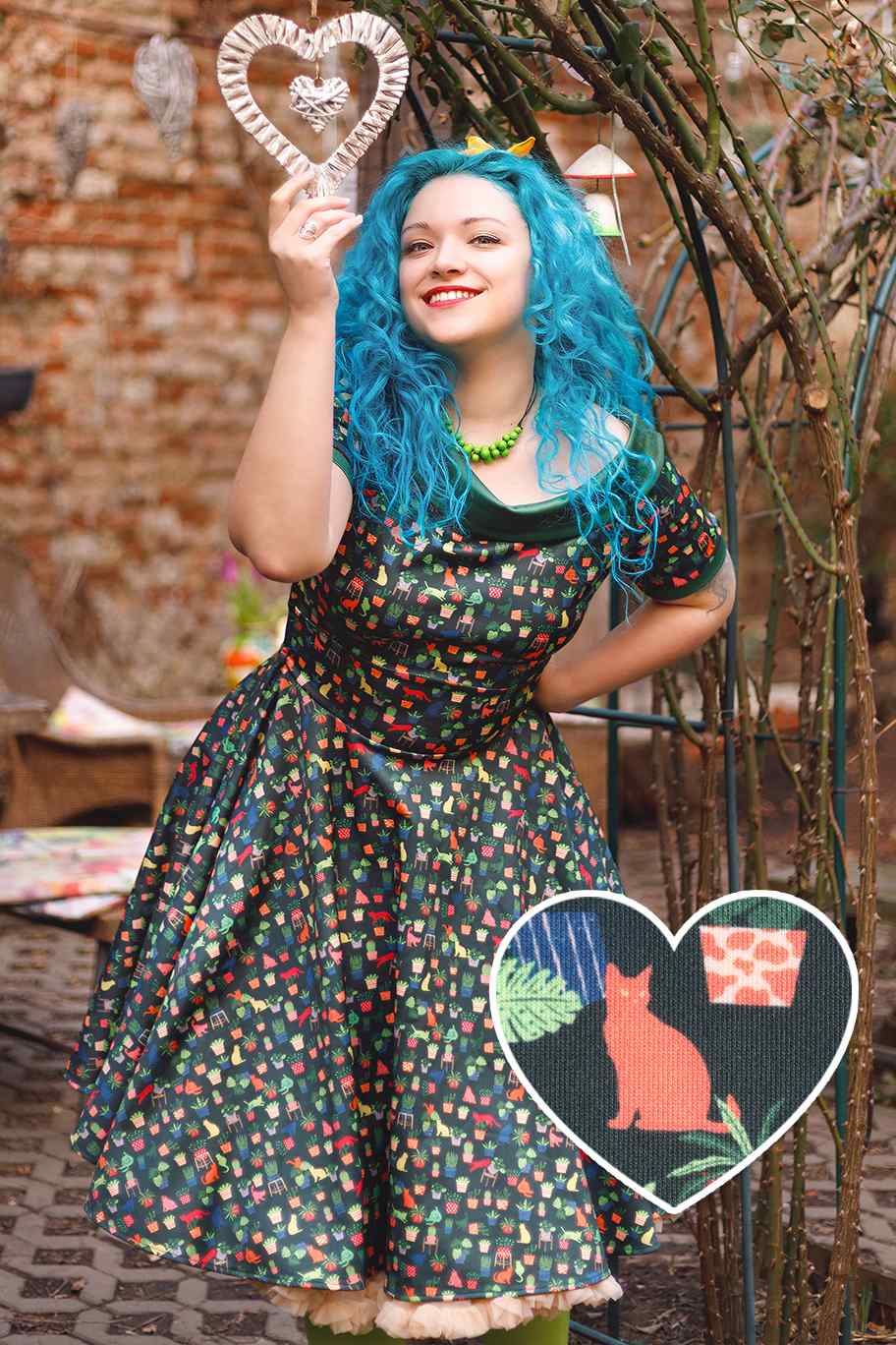 A model wearing Cat & Plant Dress In Dark Green