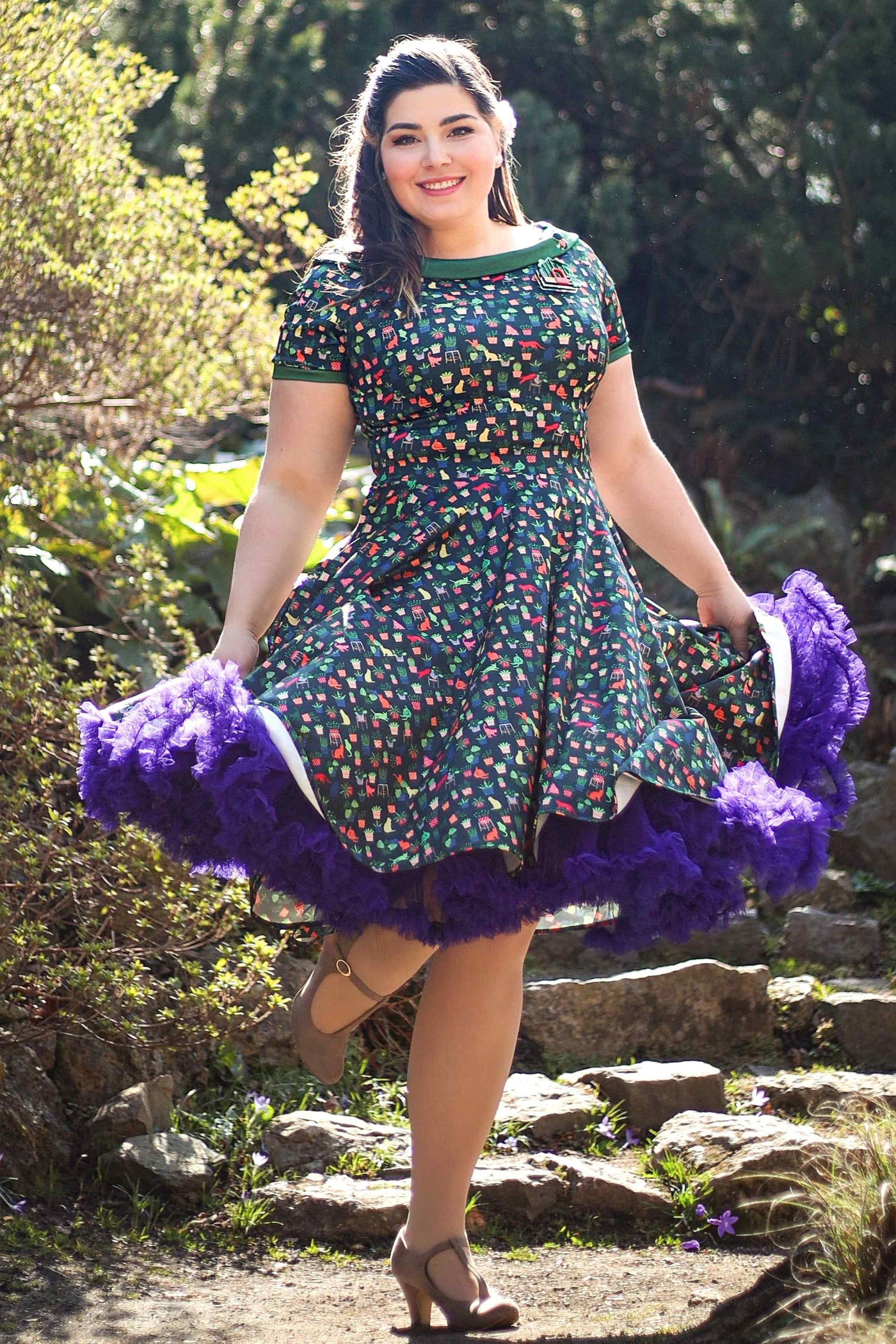 A lady wearing a Cat & Plant Dress In Dark Green
