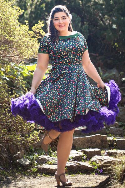 A lady wearing a Cat & Plant Dress In Dark Green