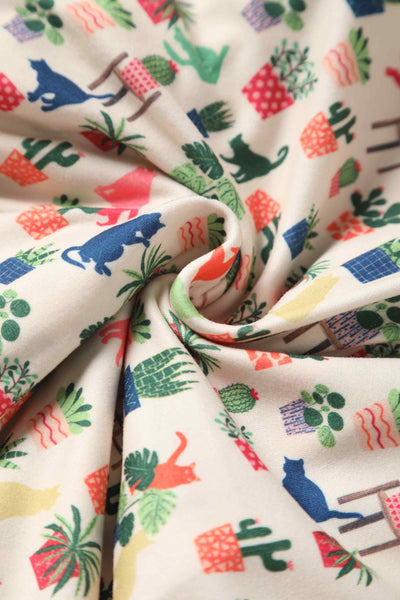 Close up view of Cat & Plant Wrap Dress In White
