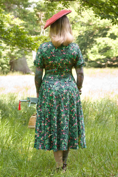 Back view of A model wearing Chameleon Midi Dress In Green
