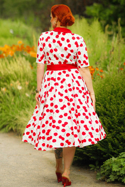 A woman wearing a Mollie Cherry Full Circle Shirt Dress In White