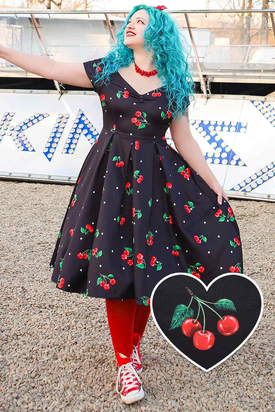 A model wearing Cherry Off Shoulder Dress In Black