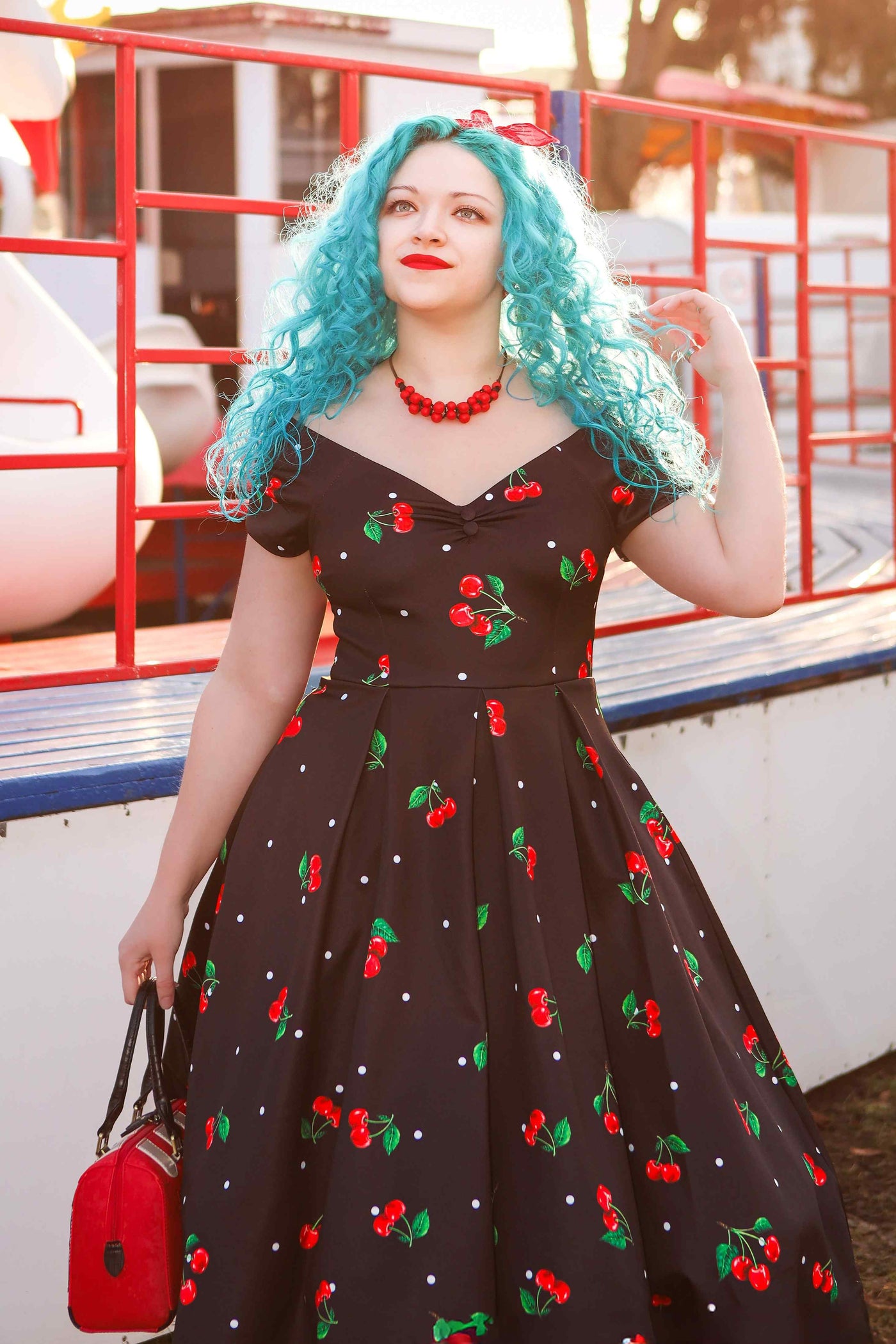 A model wearing Cherry Off Shoulder Dress In Black